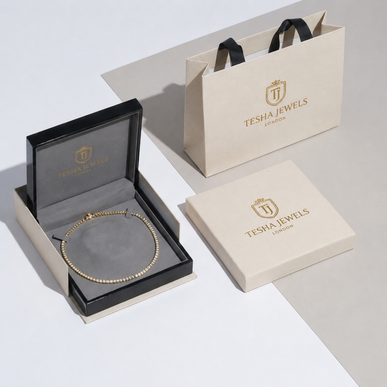 Hands holding a small jewellery gift box wrapped with ribbon